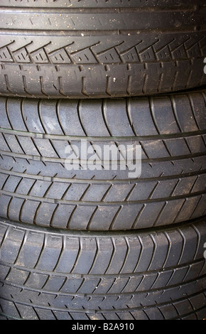 A stack of used tires in the garage Stock Photo