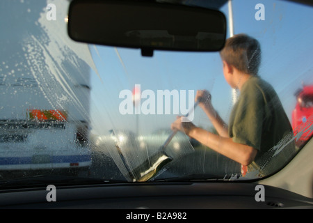A boy earning money by washing cars, Poland. Stock Photo
