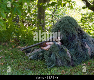 Sniper in ghillie suit with .22 calibre rifle Stock Photo