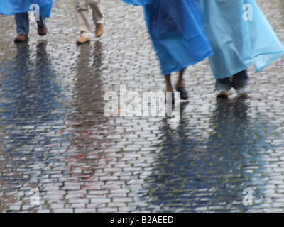 tourists people wearing waterproof coat capes in rain Stock Photo