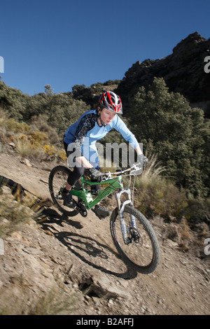 Female Mountain Biker Rides in Sierra Nevada, Spain Stock Photo