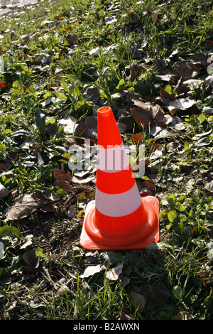 one single traffic cone in field on country lane Stock Photo