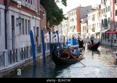 Tourists enjoying an evening Gondola ride along the Venice canals. Stock Photo