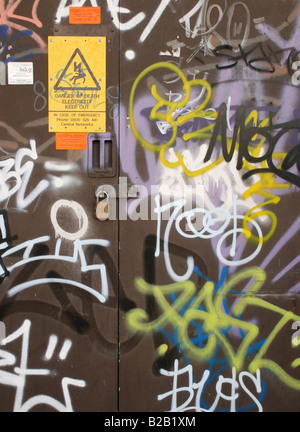 A close up view of graffiti on a brown door. This graffiti has been painted over and  no longer exists. Stock Photo