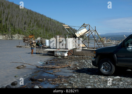 Fishing wheel hauled ashore for repairs, for automated catching of salmon in Copper River near Chitina, Alaska. Stock Photo