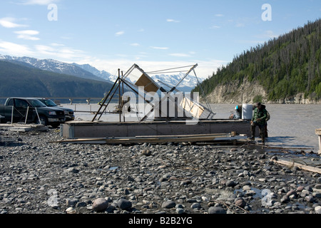 Fishing wheel hauled ashore for repairs, for automated catching of salmon in Copper River near Chitina, Alaska. Stock Photo