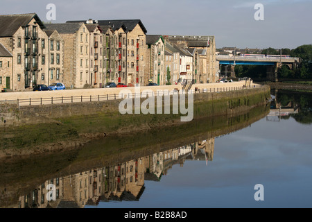 Old Warehouses, other buildings on St George's Quay and Carlisle Bridge, Lancaster and reflections in the River Lune Stock Photo