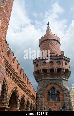 View of the tower of Oberbaum Bridge over Spree river based on the Brick Gothic Mitteltorturm in Prenzlau, Berlin Germany Stock Photo