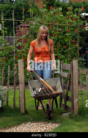Green wheelbarrow in an English country garden Stock Photo - Alamy