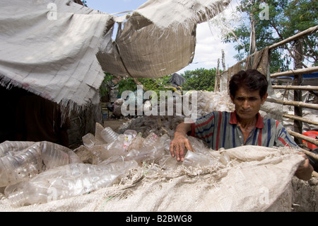 In the slums of Topsia everyone lives from waste, PET bottles are collected and packed then sold on for recycling, Calcutta Stock Photo