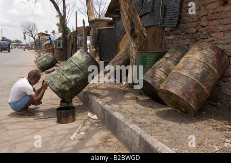 Almost everyone in the slums of Topsia earns a living from recycling waste, this man specialises in the reconditioning of old o Stock Photo