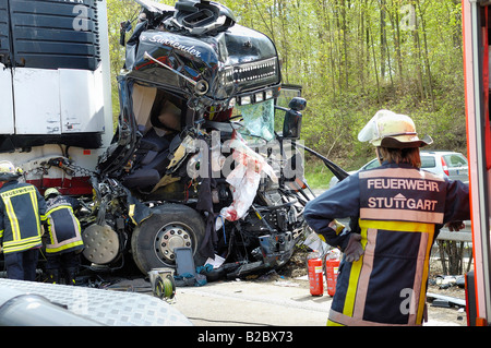 Serious lorry accident on the A8 Motorway, professional fireman from Stuttgart at the scene of the accident, his colleagues are Stock Photo