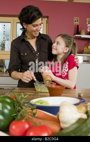 Mother and daughter cooking together Stock Photo