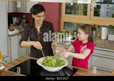 Mother and daughter cooking together Stock Photo