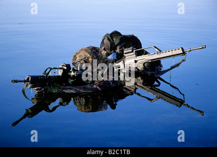 Two soldiers belonging to the Kampfschwimmerkompanie, combat swimmers, special unit of the German Navy practicing an attack on  Stock Photo