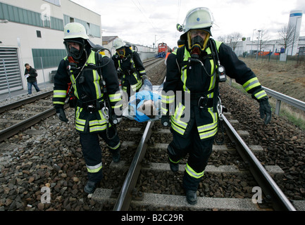 Firemen wearing breathing apparatus rescuing actors during a disaster control drill, near Poing, Bavaria, Germany, Europe Stock Photo