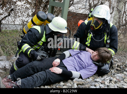 Firemen wearing breathing apparatus rescuing actors during a disaster control drill, near Poing, Bavaria, Germany, Europe Stock Photo