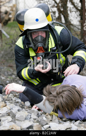 Firemen wearing breathing apparatus rescuing actors during a disaster control drill, near Poing, Bavaria, Germany, Europe Stock Photo