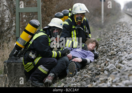 Firemen wearing breathing apparatus rescuing actors during a disaster control drill, near Poing, Bavaria, Germany, Europe Stock Photo