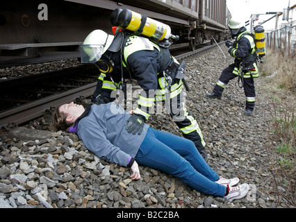 Firemen wearing breathing apparatus rescuing actors during a disaster control drill, near Poing, Bavaria, Germany, Europe Stock Photo