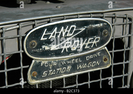 Land Rover enblem on grey 1950's Land Rover Series One 86 inch Station Wagon. Stock Photo