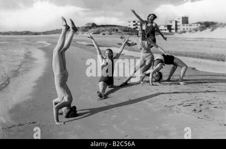 Women doing gymnastics on the beach, historic picture from about 1940 Stock Photo