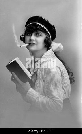 Modern youth, woman reading a book and smoking, historic picture from about 1910 Stock Photo