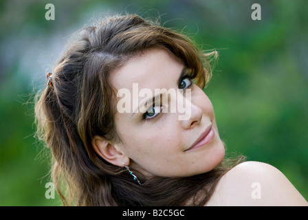 young woman looking over her shoulder Stock Photo