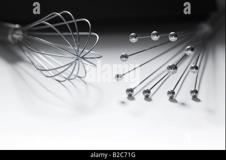 Two stainless steel eggbeaters or egg whisks Stock Photo