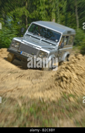 Off roading silver metallic Land Rover Defender 110 TD5 by Land Rover Experience used for driver training. Europe, UK, England. Stock Photo