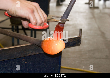 Glass works. End of rod with molten glass used by glass blower worker. 60790 Dartington-Glass Stock Photo