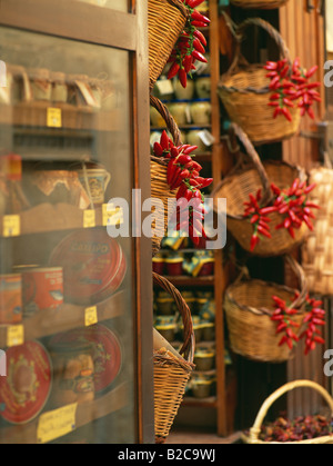 Red chillies hanging in baskets in deli shop Tropea Calabria Italy Stock Photo
