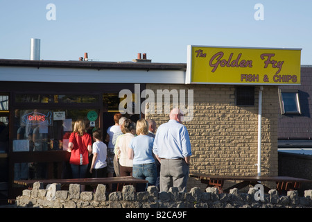 People queuing outside The Golden Fry fish and chip shop in summer. Benllech Anglesey North Wales UK, Britain Stock Photo