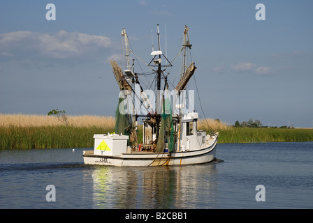 shrimp trawler heads out for day of shrimping Apalachicola Florida Stock Photo