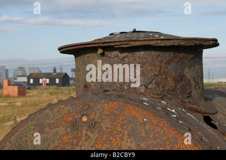 Rusting machinery with Dungeness Nuclear Power Station in the background Stock Photo