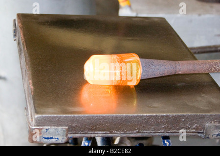 Glass works. End of rod with molten glass used by glass blower worker. 60865 Dartington-Glass Stock Photo