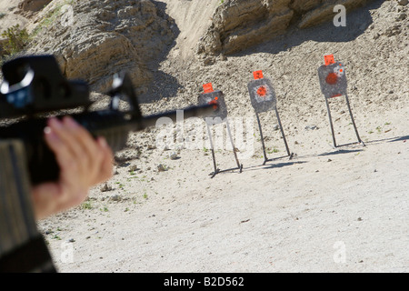 Man aiming machine gun at firing range, close up of hands Stock Photo