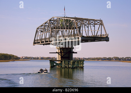 Boats pass under the Sullivan s Island South Carolina swing bridge along the Intercoastal Waterway near Charleston Stock Photo