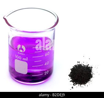 Crystals of Potassium Permanganate and a Beaker containing Purple Potassium Permanganate Solution Stock Photo