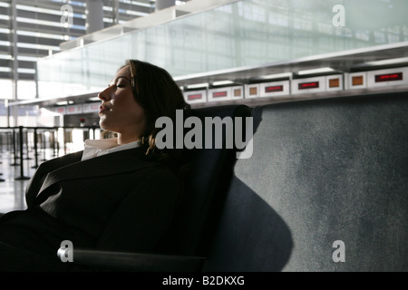 Young businesswoman resting in airport. Stock Photo