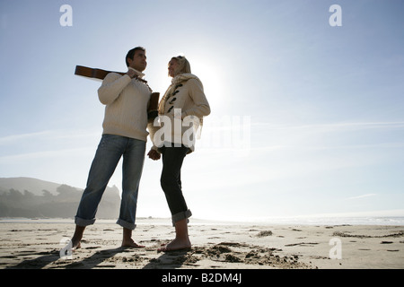 Young couple relaxing on beach in winter. Stock Photo