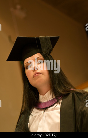 looking up at woman student wearing mortar board and gown at Aberystwyth University graduation day 2008, Wales UK Stock Photo