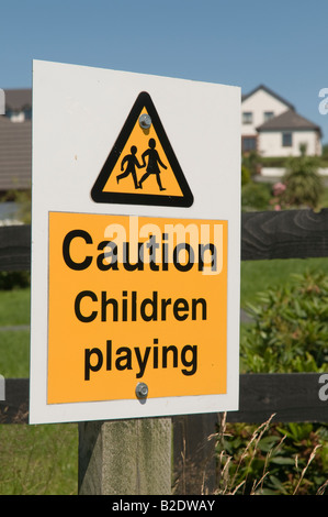 Caution children playing sign - black lettering on yellow background Stock Photo