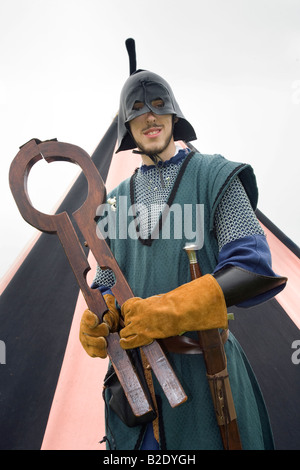 Shrew's Fiddle, neck violin or Shrew's Fife, wooden neck restraint held by Masked Executioner (MR), Knights of Monymusk, re-enactment group, Scotland Stock Photo