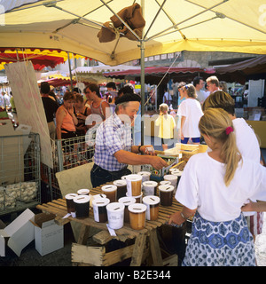 Beekeeper selling his honey at weekly street market Les Vans Ardèche France Stock Photo