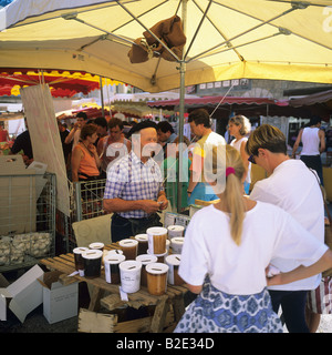 Beekeeper selling his honey at weekly street market Les Vans Ardèche France Stock Photo