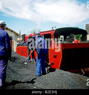 Railwaymen coaling steam engine of Chemin de fer du Vivarais tourist train at Lamastre station Ardèche France Europe Stock Photo