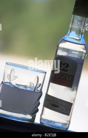 A glass and bottle of Ouzo Crete Greece Stock Photo