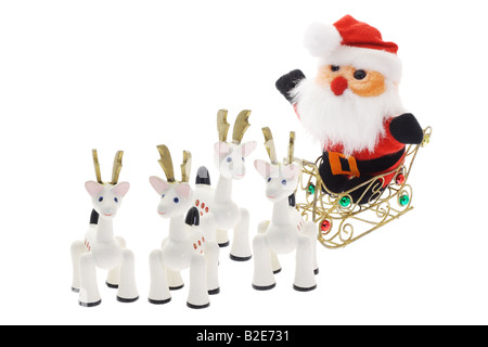 Santa Claus riding on sledge with reindeer on white background Stock Photo
