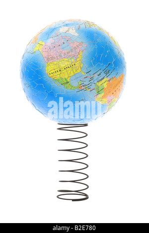 Globe showing America bouncing on metal spring reflecting the state of economy Stock Photo